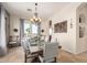Elegant dining room featuring a chandelier, neutral decor, and French doors leading to outdoor views at 9753 E Suncrest Rd, Scottsdale, AZ 85262