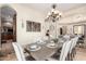 Open-concept dining room with seating for eight, chandelier lighting, and views of the living area at 9753 E Suncrest Rd, Scottsdale, AZ 85262