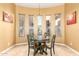 Breakfast nook with four windows, tile floors, decorative lighting, and table for four at 9753 E Suncrest Rd, Scottsdale, AZ 85262