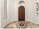 Spacious foyer featuring tiled floors, a decorative inlay, and a solid wood front door at 9753 E Suncrest Rd, Scottsdale, AZ 85262