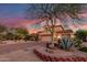 Beautiful home with desert landscaping, a paver driveway, and a majestic tree at 9753 E Suncrest Rd, Scottsdale, AZ 85262