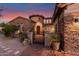 Stunning home featuring stone accents, a gated courtyard, and desert landscaping at 9753 E Suncrest Rd, Scottsdale, AZ 85262