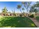 Beautiful backyard features a putting green, mature trees, desert landscaping, and is fully fenced at 9753 E Suncrest Rd, Scottsdale, AZ 85262