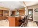 Kitchen featuring a breakfast bar with seating, granite countertops, and wood cabinetry at 9753 E Suncrest Rd, Scottsdale, AZ 85262