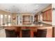 Open kitchen with bar seating, granite counters, stainless steel appliances, and ample cabinet space at 9753 E Suncrest Rd, Scottsdale, AZ 85262
