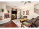 Bright living room with a fireplace, TV, staircase, and comfortable furniture, creating a cozy atmosphere at 9753 E Suncrest Rd, Scottsdale, AZ 85262