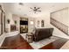 Relaxing living room with a fireplace, media center, and staircase, designed for comfort and entertainment at 9753 E Suncrest Rd, Scottsdale, AZ 85262
