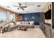 Cozy living room boasts ample seating, a ceiling fan, and backyard views at 9753 E Suncrest Rd, Scottsdale, AZ 85262