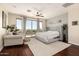Bright main bedroom featuring balcony access, hardwood floors, and a cozy seating area at 9753 E Suncrest Rd, Scottsdale, AZ 85262