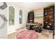 Bright home office with large windows, custom shelving, and tile flooring at 9753 E Suncrest Rd, Scottsdale, AZ 85262