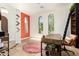 Bright office featuring arched windows, a modern desk, and a playful orange accent wall at 9753 E Suncrest Rd, Scottsdale, AZ 85262