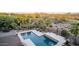 Outdoor pool and backyard featuring mature palms, desert landscaping and serene desert views at 9753 E Suncrest Rd, Scottsdale, AZ 85262