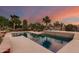 A stunning backyard pool with water feature, desert landscaping, lounge chairs, and serene desert views at 9753 E Suncrest Rd, Scottsdale, AZ 85262