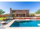 Large backyard with refreshing pool, comfortable outdoor seating, and mature landscaping for privacy at 9753 E Suncrest Rd, Scottsdale, AZ 85262