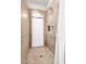 Tiled shower with glass enclosure, decorative tile accents, and built-in shelving for toiletries at 9753 E Suncrest Rd, Scottsdale, AZ 85262