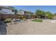 Desert-landscaped backyard featuring a rock water feature and artificial turf area, perfect for outdoor enjoyment at 1031 W Longhorn Dr, Chandler, AZ 85286
