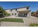 Rear exterior view of the home highlighting the covered patio, and desert landscape at 1031 W Longhorn Dr, Chandler, AZ 85286