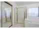 Bright bathroom featuring a glass enclosed shower and tub with a window, creating a relaxing atmosphere at 1031 W Longhorn Dr, Chandler, AZ 85286