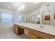 Bathroom featuring a double sink vanity, bath tub, large mirror and natural light at 1031 W Longhorn Dr, Chandler, AZ 85286