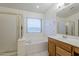 Bathroom with separate tub and shower, single sink vanity, and natural light at 1031 W Longhorn Dr, Chandler, AZ 85286