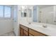 Well-lit bathroom with a double sink vanity, mirrors, and tile flooring, combining style and functionality at 1031 W Longhorn Dr, Chandler, AZ 85286
