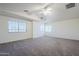 Bedroom featuring carpet, large windows, vaulted ceiling, and a ceiling fan at 1031 W Longhorn Dr, Chandler, AZ 85286