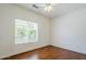 Bright bedroom with hardwood floors, a ceiling fan, and a window with verdant views at 1031 W Longhorn Dr, Chandler, AZ 85286