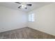 Bright bedroom with neutral carpeting, a ceiling fan, and a window for natural light at 1031 W Longhorn Dr, Chandler, AZ 85286