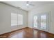 Bedroom with wood floors, a ceiling fan, and a door to the backyard at 1031 W Longhorn Dr, Chandler, AZ 85286