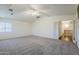 Bedroom with carpet, vaulted ceiling, ceiling fan, and hallway access at 1031 W Longhorn Dr, Chandler, AZ 85286
