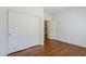 Bedroom featuring wood floors and double door closet with entry to hallway at 1031 W Longhorn Dr, Chandler, AZ 85286