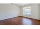 Bedroom showcasing hardwood floors and a large window for natural light at 1031 W Longhorn Dr, Chandler, AZ 85286