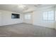 Carpeted bedroom with vaulted ceiling, fan, large windows, and a mounted TV at 1031 W Longhorn Dr, Chandler, AZ 85286