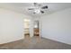 Comfortable bedroom with neutral carpeting, a ceiling fan, a closet, and easy access to the hallway at 1031 W Longhorn Dr, Chandler, AZ 85286
