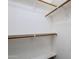 Well-organized walk-in closet with wooden rods and shelves, providing ample storage for clothes and accessories at 1031 W Longhorn Dr, Chandler, AZ 85286