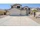 Expansive driveway and three-car garage in this two-story house with desert landscaping at 1031 W Longhorn Dr, Chandler, AZ 85286