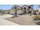 Inviting two-story home with neutral color palette, desert landscaping, and attached two-car garage at 1031 W Longhorn Dr, Chandler, AZ 85286