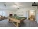Spacious game room featuring a wooden pool table, soft carpet, and a view to the hall at 1031 W Longhorn Dr, Chandler, AZ 85286