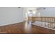 Upstairs hallway with hardwood floors and a wooden railing at 1031 W Longhorn Dr, Chandler, AZ 85286