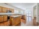 Spacious kitchen featuring hardwood floors, stainless steel appliances, wood cabinets, and granite countertops at 1031 W Longhorn Dr, Chandler, AZ 85286