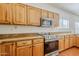 Modern kitchen features stainless steel appliances, granite countertops, and wooden cabinets at 1031 W Longhorn Dr, Chandler, AZ 85286