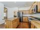 Modern kitchen featuring hardwood floors, stainless steel appliances, wooden cabinets, and a center island at 1031 W Longhorn Dr, Chandler, AZ 85286