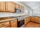 Modern kitchen features stainless steel appliances, granite countertops, and wooden cabinets at 1031 W Longhorn Dr, Chandler, AZ 85286