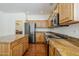 Modern kitchen featuring stainless steel appliances, wooden cabinets, hardwood floors and a center island at 1031 W Longhorn Dr, Chandler, AZ 85286