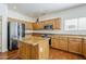Traditional kitchen features an island, stainless steel appliances, and wood cabinetry at 1031 W Longhorn Dr, Chandler, AZ 85286