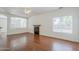 Living room with a fireplace, ceiling fan and wood floors at 1031 W Longhorn Dr, Chandler, AZ 85286