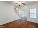 Spacious living area features beautiful hardwood floors, a staircase, and large window at 1031 W Longhorn Dr, Chandler, AZ 85286