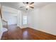Bright living room with hardwood floors, ceiling fan, and natural light coming through the window at 1031 W Longhorn Dr, Chandler, AZ 85286