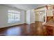Bright living room featuring wood flooring, a staircase, and ample natural light at 1031 W Longhorn Dr, Chandler, AZ 85286