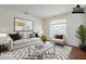 Bright living room featuring a modern sofa, stylish decor, and ample natural light at 1031 W Longhorn Dr, Chandler, AZ 85286
